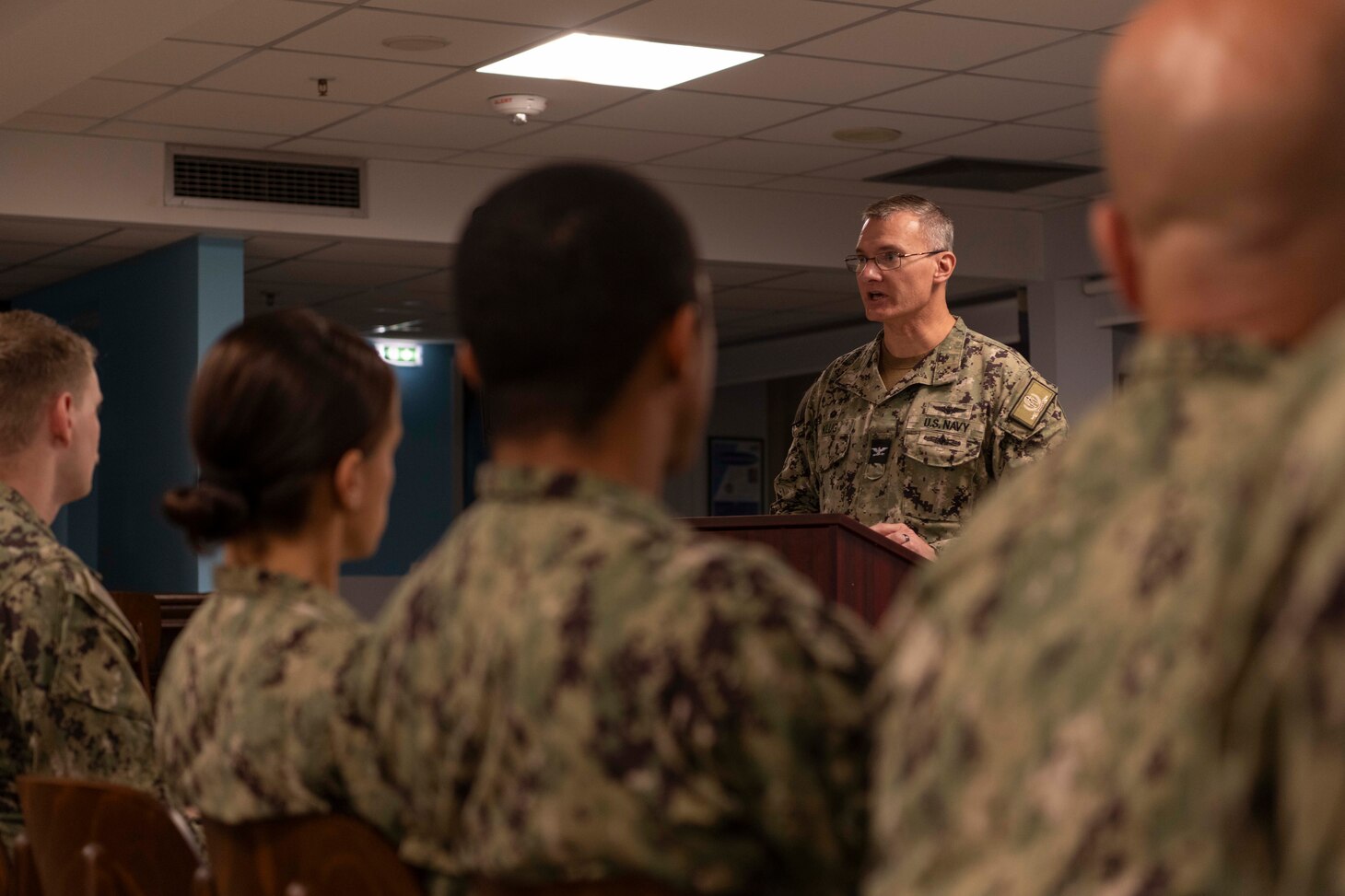 Capt. Odin J. Klug, commanding officer, Naval Support Activity Souda Bay, talks about U.S. Navy Veteran and Alaska Native Solomon Atkinson during a National American Indian Heritage Month event sponsored by the NSA Souda Bay Multicultural Heritage Committee on Nov. 30, 2023.
