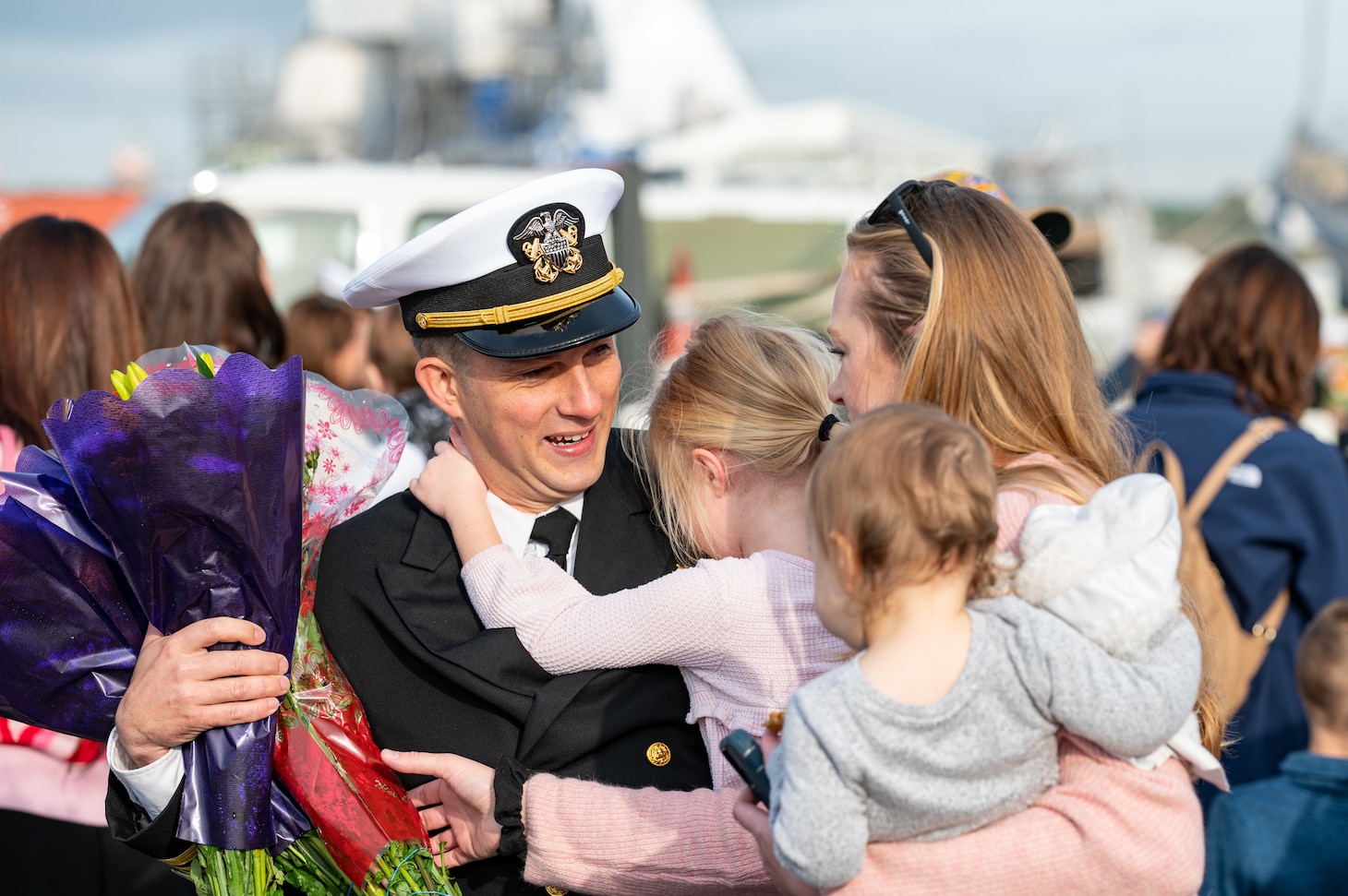 A Sailor assigned to the Arleigh Burke-class guided-missile destroyer USS Paul Ignatius (DDG 117) greets his family on the pier at Naval Station (NAVSTA) Rota as the ship returns from deployment, Nov. 28, 2023. As the "Gateway to the Mediterranean,” NAVSTA Rota provides U.S, NATO and allied forces a strategic hub for operations in Europe, Africa and the Middle East. NAVSTA Rota is a force multiplier, capable of promptly deploying and supporting combat-ready forces through land, air and sea, enabling warfighters and their families, sustaining the fleet and fostering the U.S. and Spanish partnership. (U.S. Navy photo by Mass Communication Specialist 2nd Class Drace Wilson)