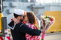 A Sailor assigned to the Arleigh Burke-class guided-missile destroyer USS Paul Ignatius (DDG 117) greets his family on the pier at Naval Station (NAVSTA) Rota as the ship returns from deployment, Nov. 28, 2023. As the "Gateway to the Mediterranean,” NAVSTA Rota provides U.S, NATO and allied forces a strategic hub for operations in Europe, Africa and the Middle East. NAVSTA Rota is a force multiplier, capable of promptly deploying and supporting combat-ready forces through land, air and sea, enabling warfighters and their families, sustaining the fleet and fostering the U.S. and Spanish partnership. (U.S. Navy photo by Mass Communication Specialist 2nd Class Drace Wilson)