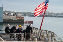 Sailors assigned to the Arleigh Burke-class guided-missile destroyer USS Paul Ignatius (DDG 117) moor the ship to the pier at Naval Station (NAVSTA) Rota as the ship returns from deployment, Nov. 28, 2023. As the "Gateway to the Mediterranean,” NAVSTA Rota provides U.S, NATO and allied forces a strategic hub for operations in Europe, Africa and the Middle East. NAVSTA Rota is a force multiplier, capable of promptly deploying and supporting combat-ready forces through land, air and sea, enabling warfighters and their families, sustaining the fleet and fostering the U.S. and Spanish partnership. (U.S. Navy photo by Mass Communication Specialist 2nd Class Drace Wilson)