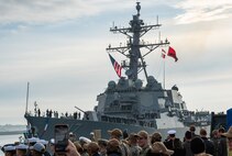 Friends and families of Sailors assigned to the Arleigh Burke-class guided-missile destroyer USS Paul Ignatius (DDG 117) gather on the pier at Naval Station (NAVSTA) Rota as the ship returns from deployment, Nov. 28, 2023. As the "Gateway to the Mediterranean,” NAVSTA Rota provides U.S, NATO and allied forces a strategic hub for operations in Europe, Africa and the Middle East. NAVSTA Rota is a force multiplier, capable of promptly deploying and supporting combat-ready forces through land, air and sea, enabling warfighters and their families, sustaining the fleet and fostering the U.S. and Spanish partnership. (U.S. Navy photo by Mass Communication Specialist 2nd Class Drace Wilson)