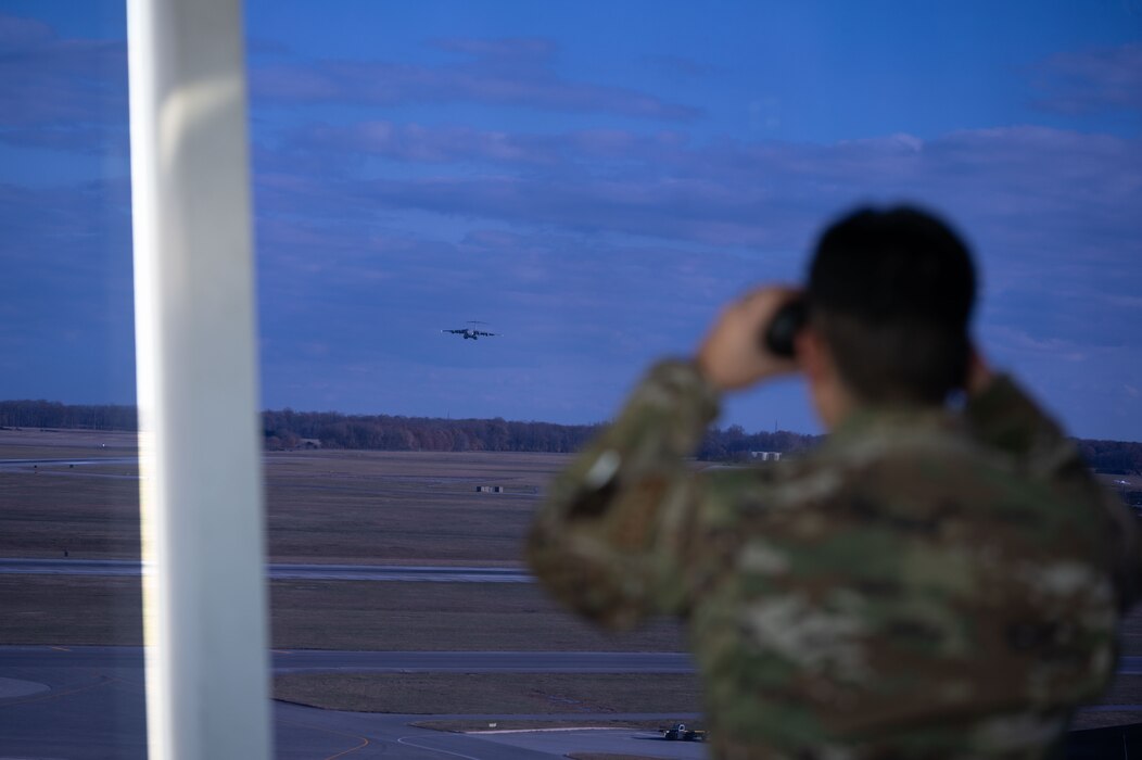 A 436th Operations Support Squadron air traffic controller watches a C-5M Super Galaxy at Dover Air Force Base, Delaware, Nov. 27, 2023. The 436th OSS provides air traffic control, weather, intelligence, mission planning and more to ensure that Team Dover is always prepared to provide rapid global transportation. (U.S. Air Force photo by Airman 1st Class Dieondiere Jefferies)
