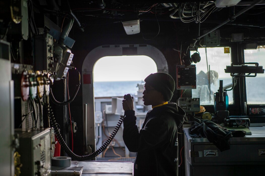 BM2 Avery Matthews makes an announcement over the ship-wide communication system aboard USS Kidd (DDG 100).