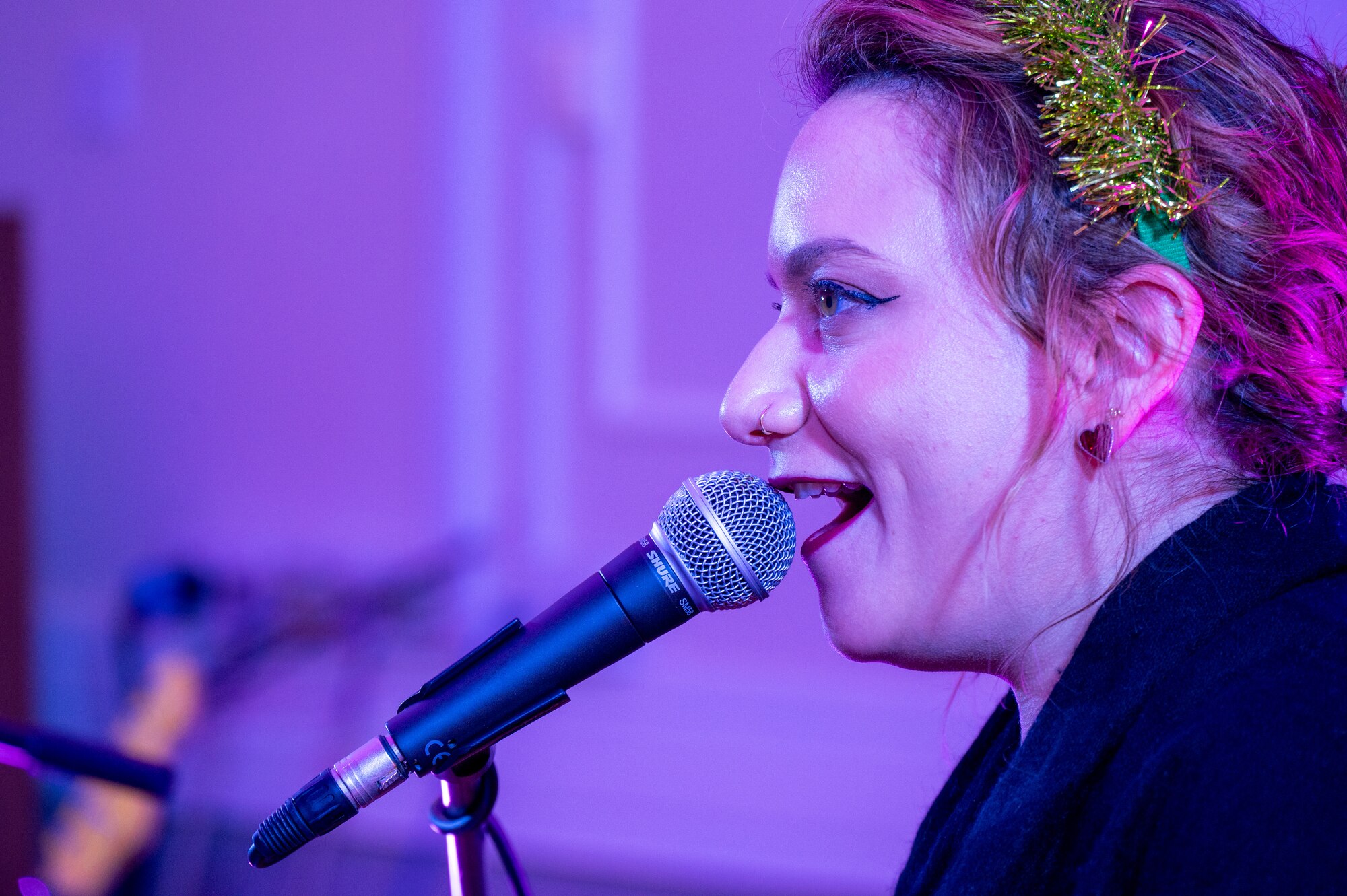 A performer sings into a microphone.