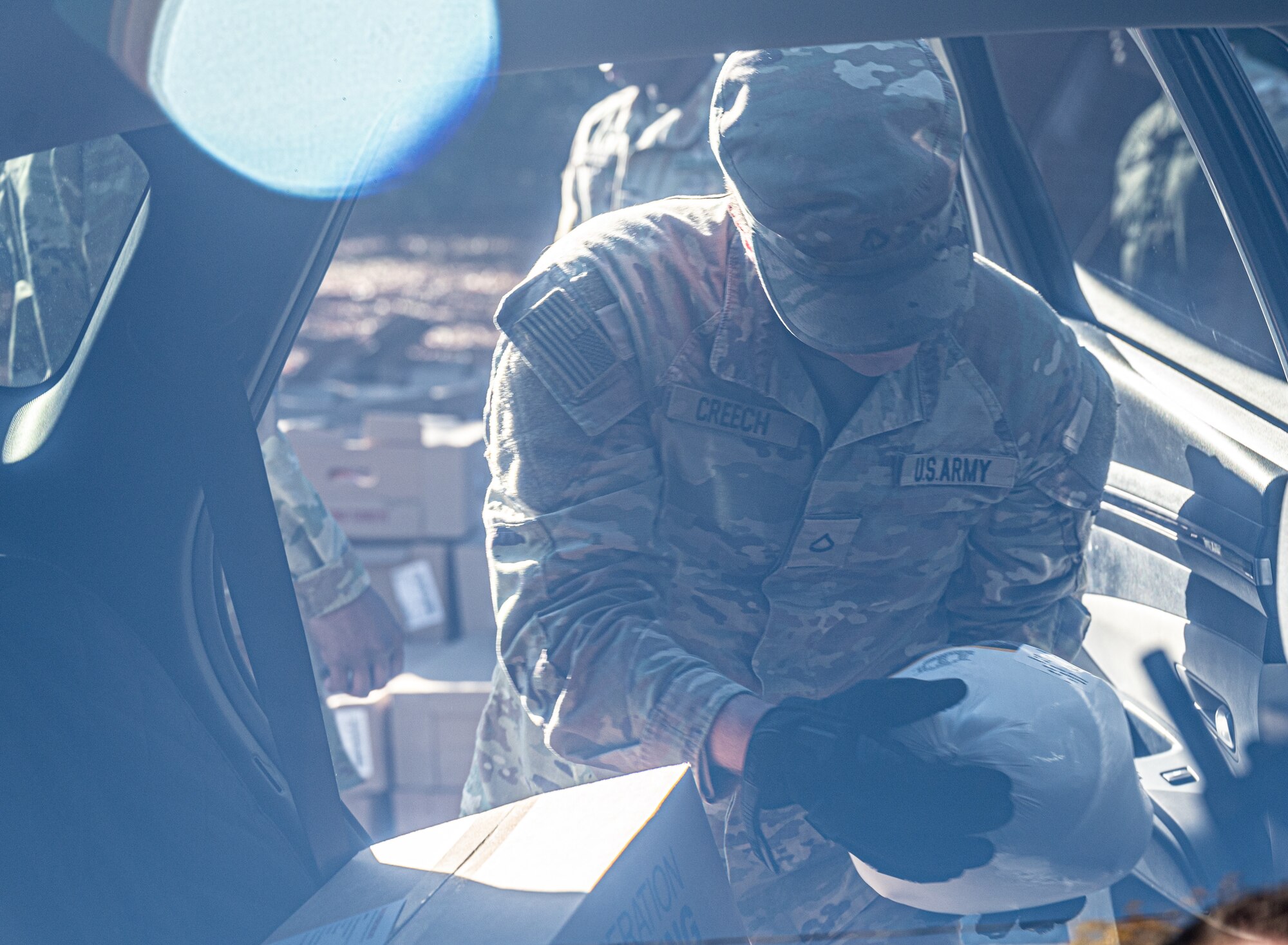 Soldier puts a turkey in a car