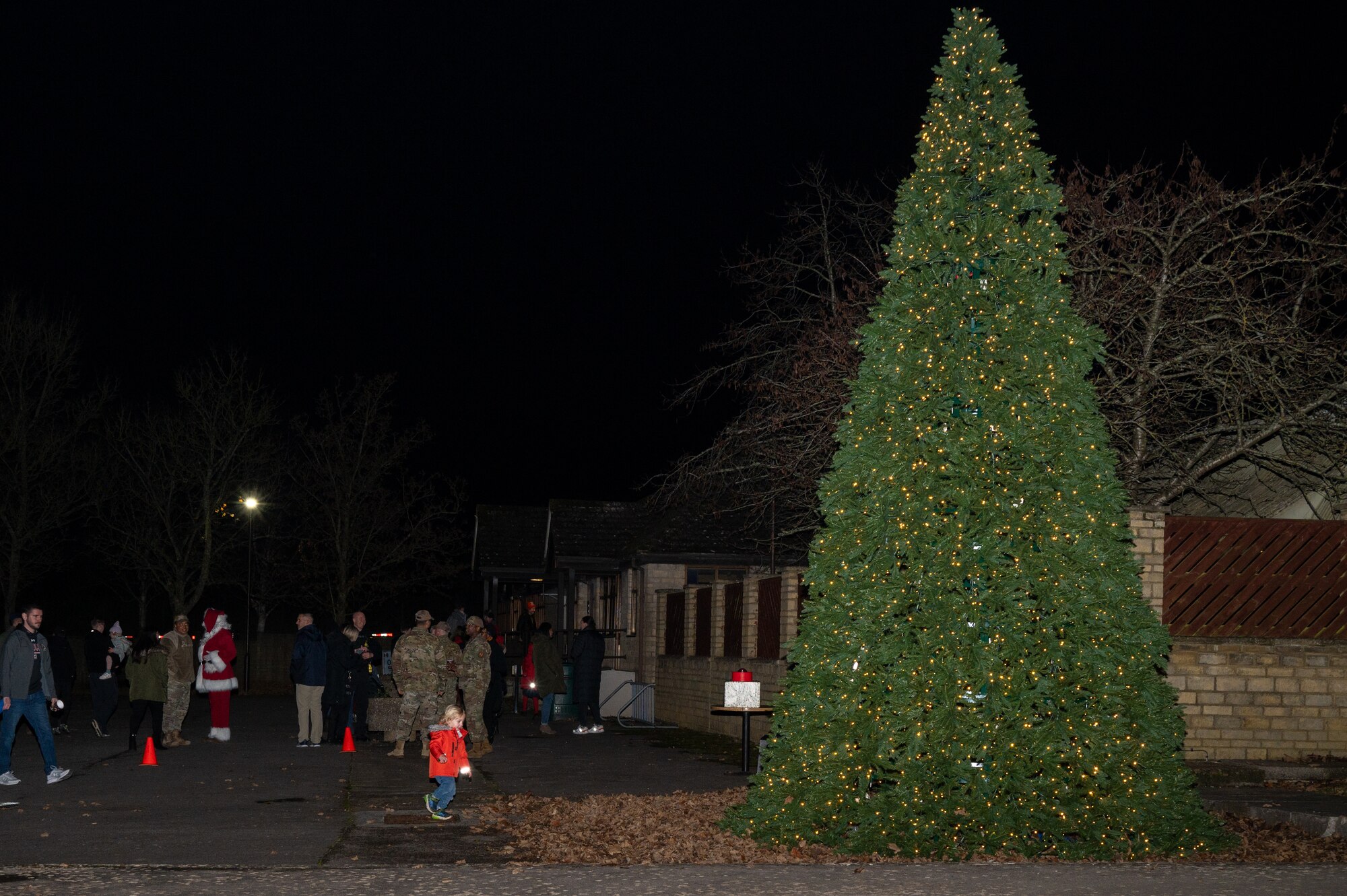 Community members gather after a tree lighting ceremony.