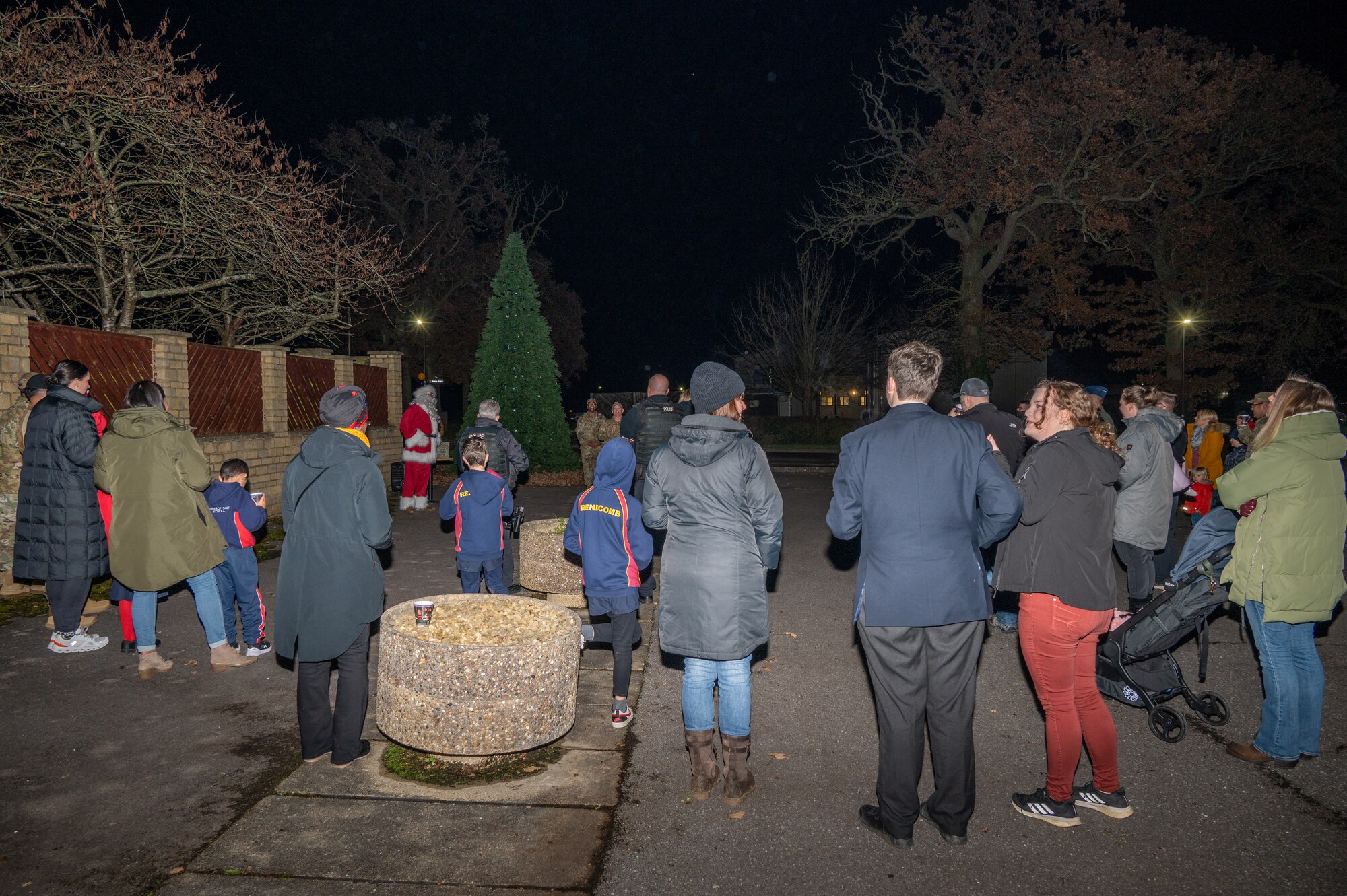Community members gather for a tree lighting ceremony.
