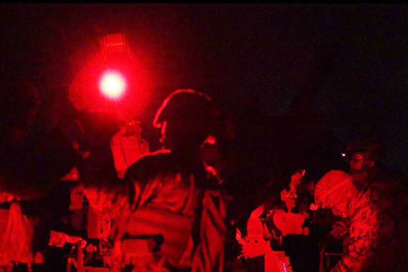 Marines fire a weapon a night.
