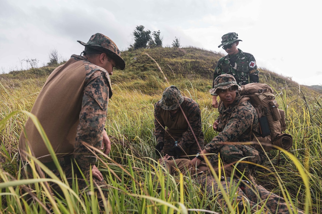 U.S. Marines with Marine Rotational Force-Southeast Asia, I Marine Expeditionary Force and Indonesian Marines with 4th Marine Infantry Brigade, Pasmar 1, provide tactical combat casualty care at a casualty evacuation subject matter expert exchange during Keris Marine Exercise 2023 at Piabung Training Area in Sukabumi, West Java, Indonesia, Nov. 30, 2023. Keris MAREX is a bilateral exercise led by the U.S. Marine Corps and the Indonesian Marine Corps, or Korps Marinir, to promote military interoperability and maritime domain awareness capabilities, strengthen relationships, and expand military capabilities among participating forces in the advancement of a Free and Open Indo-Pacific. MRF-SEA is a Marine Corps Forces Pacific operational model that involves exchanges with subject matter experts, promotes security goals with Allies and partners, and positions I MEF forces west of the International Date Line. (U.S. Marine Corps photo by Cpl. Dean Gurule)