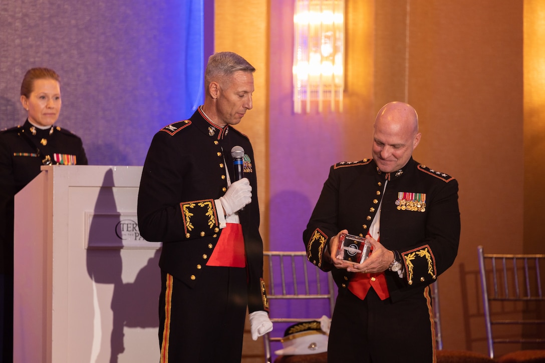 U.S. Marine Corps Col. Matthew Swindle, left, outgoing commanding officer of the Marine Innovation Unit, presents Lt. Gen. David G. Bellon, commander of Marine Forces Reserve and Marine Forces, South, a gift during a Marine Corps' 248th birthday ball, Queens, New York, Nov. 5, 2023. Stood up in March 2022, MIU leverages existing Marine talent in order to: accelerate the adoption of advanced capabilities; transform Naval Service capacity for technology employment; and retain and invest in Total Force human capital. (U.S. Marine Corps photo by Lance Cpl. David Intriago)