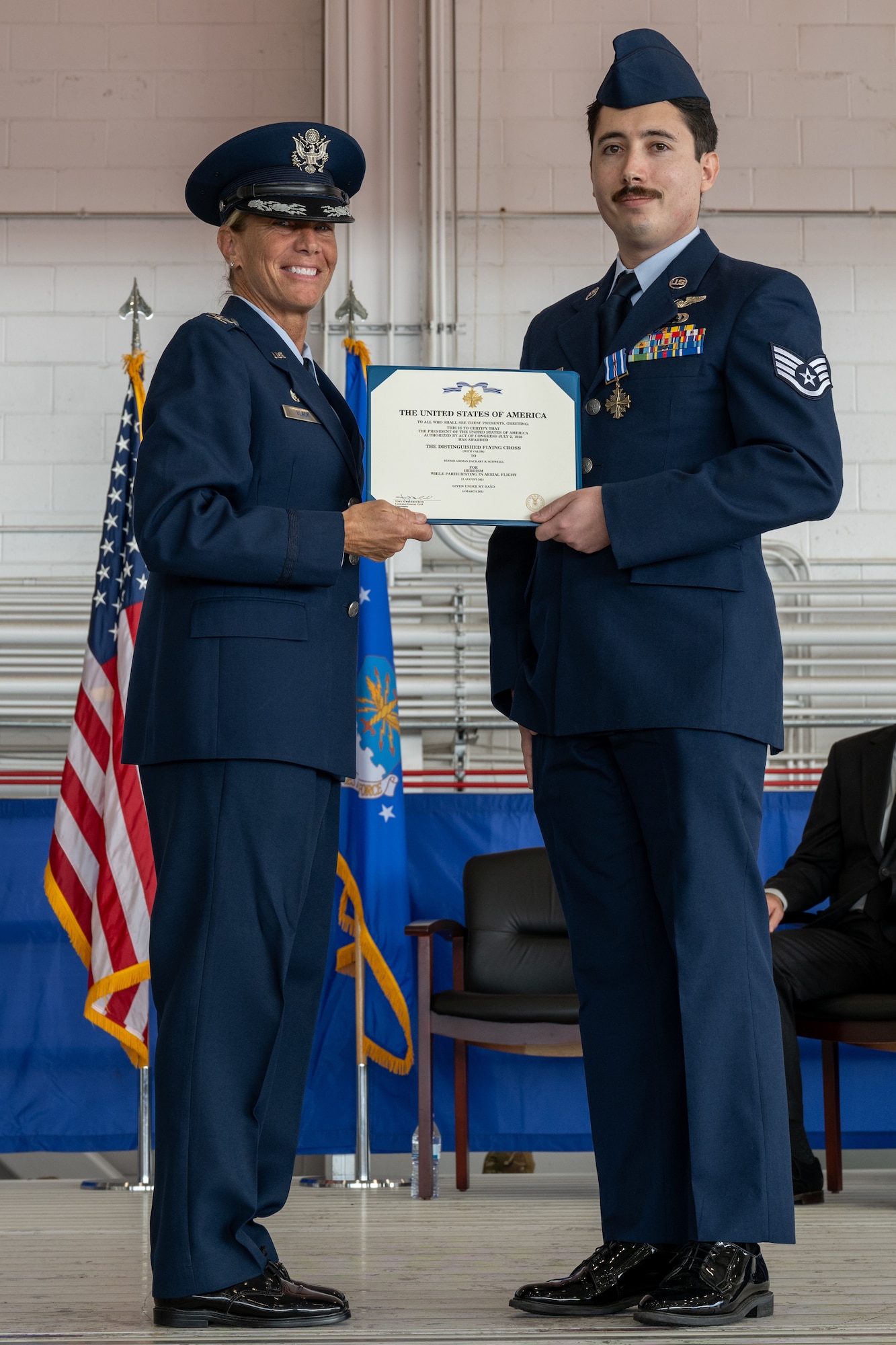 Two individuals hold a certificate.