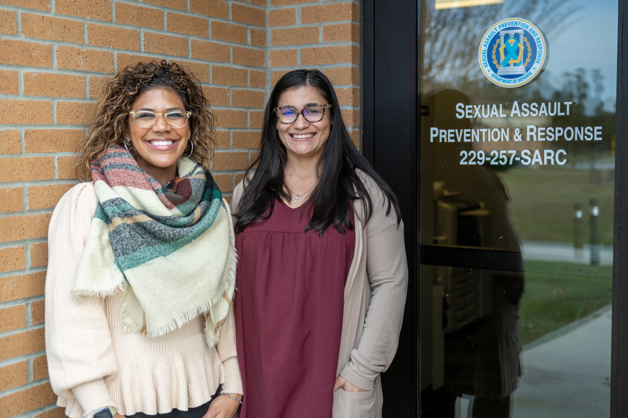 Luzmeilyn Camper, left, Moody Air Force Base sexual assault response coordinator, and Camille Santana, Sexual Assault Prevention and Response victim advocate, pose for a photo