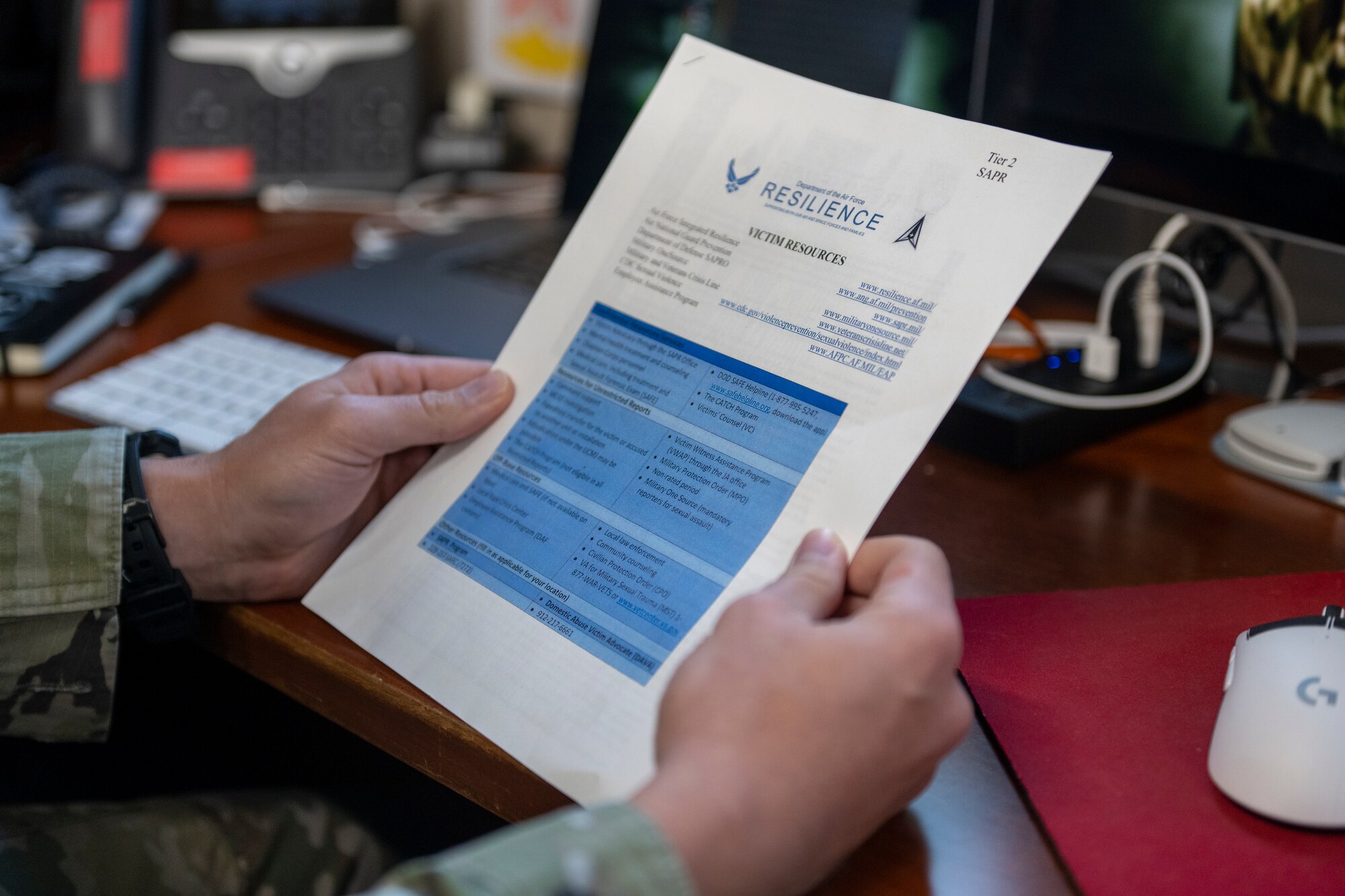 A U.S. Air Force Airman reads a resources flyer at Moody Air Force Base, Georgia, Nov. 30, 2023