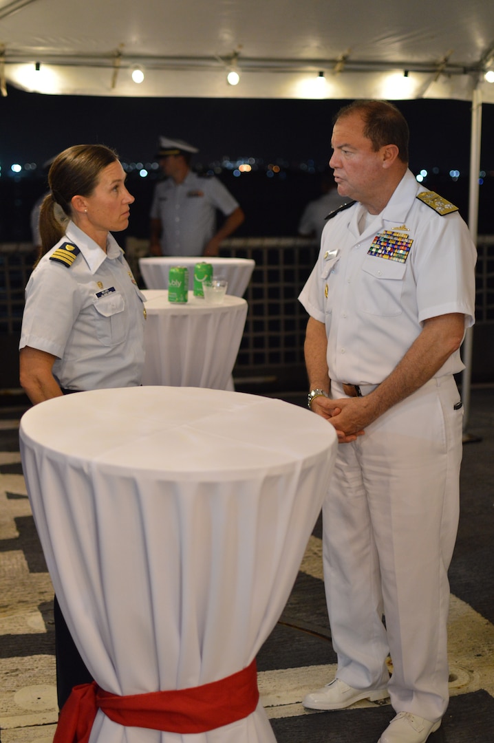 U.S. Coast Guard Cutter Bear`s (WMEC 901) Commanding Officer Cmdr. Brooke Millard, left, speaks with the Colombian Chief of Naval Operations Vice Adm. Orlando Enrique Grisales Franceschi, right, at a reception hosted aboard Bear in Cartagena, Colombia, Nov. 14, 2023. Bear's crew cross-trained with the Colombian Navy, sharing  maritime safety and security tactics.(U.S. Coast Guard photo by Ensign Melody Silva)