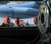 Rear Adm. Robert Wirth, J5N, U.S. Strategic Command deputy director, strategic targeting and nuclear mission planning, is briefed by Tech. Sgt. Bryce Gex, 5th Maintenance Group weapons load crew standardization member, on the capabilities of the B-52H Stratofortress at Minot Air Force Base, North Dakota, Nov. 29, 2023. During his visit to Minot, Wirth toured a B-52H Stratofortress static display and a weapons loader trainer. (U.S. Air Force photo by Airman 1st Class Alexander Nottingham)