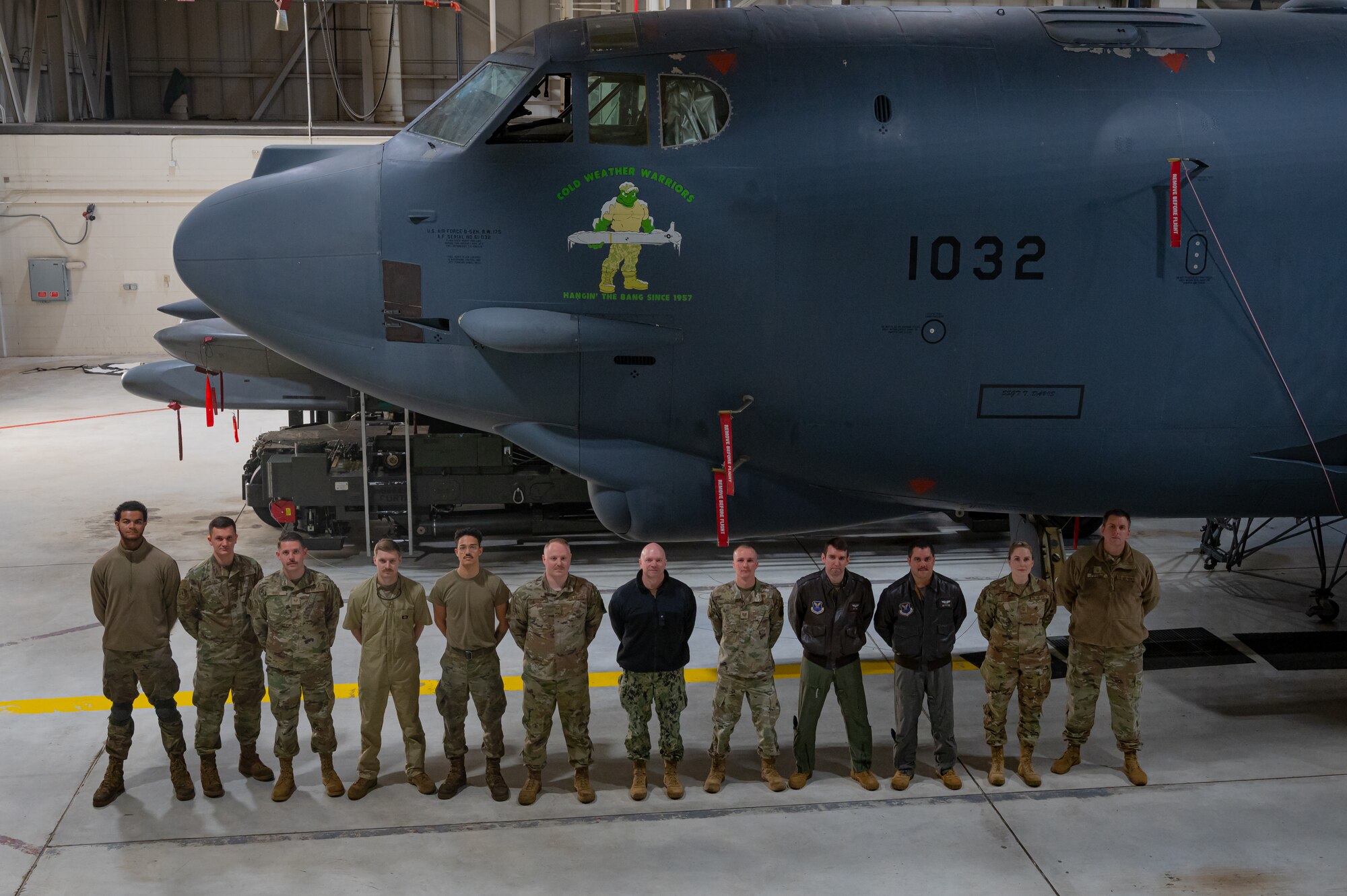 Rear Adm. Robert Wirth, J5N, U.S. Strategic Command deputy director, strategic targeting and nuclear mission planning, poses for a group photo with members of the 5th Bomb Wing at Minot Air Force Base, North Dakota, Nov. 29, 2023. Wirth visited the 5th Bomb Wing to meet with wing leaders and interact with Airmen. (U.S. Air Force photo by Airman 1st Class Alexander Nottingham)