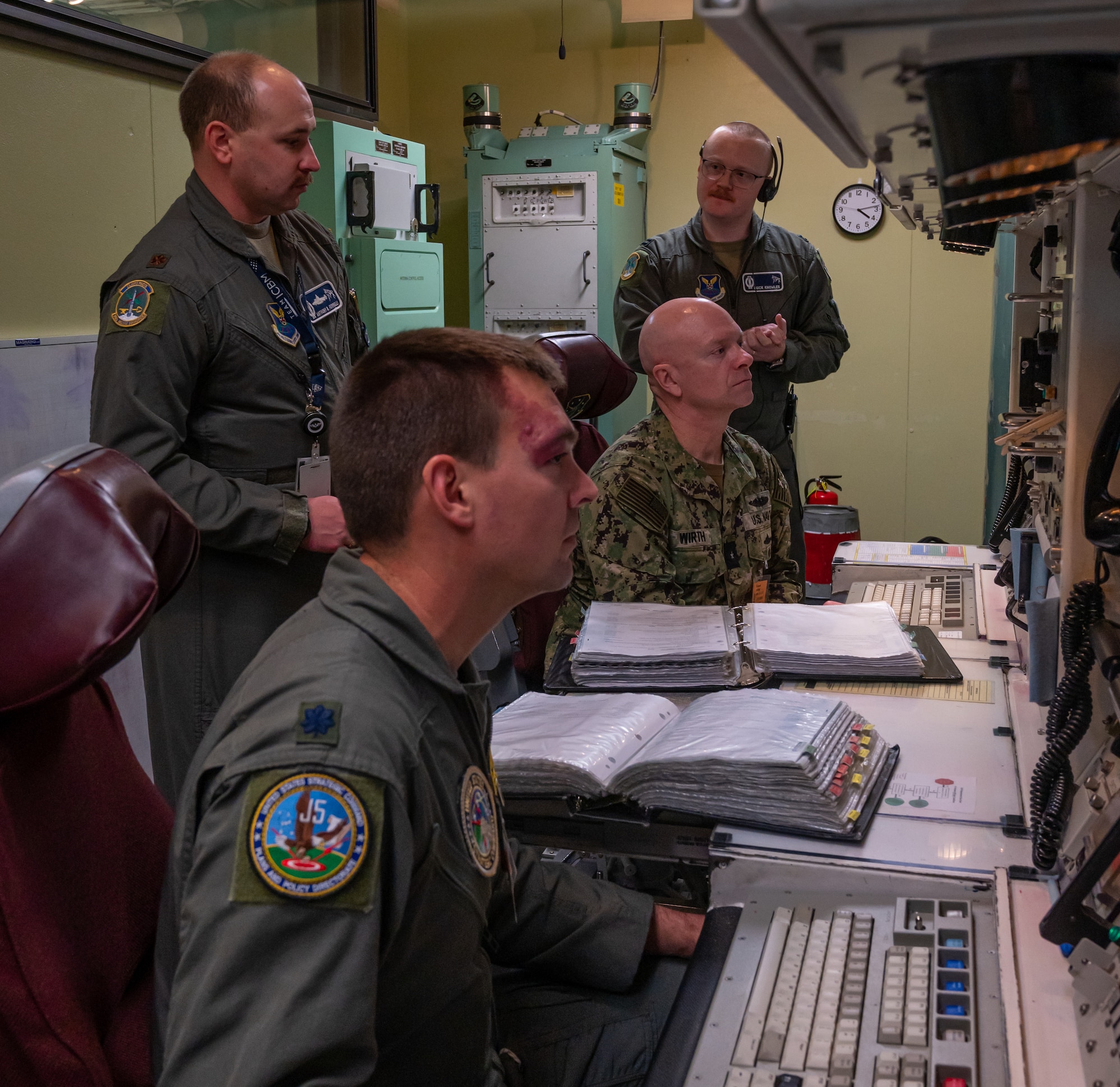Rear Adm. Robert Wirth, J5N, U.S. Strategic Command deputy director, strategic targeting and nuclear mission planning, receives a demonstration at a Missile Procedure Trainer (MPT) at Minot Air Force Base, North Dakota, Nov. 29, 2023. The MPT mimics the environment of a launch control center which is used in the field to monitor and control missile launch facilities. (U.S. Air Force photo by Airman 1st Class Alexander Nottingham)