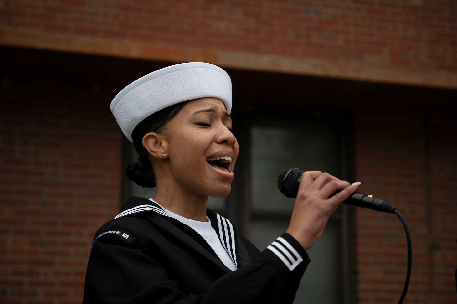 Personnel Specialist 3rd Class Sheaon Howard sings the national anthem during the launch ceremony for Mobilization and Deployment Support Command.