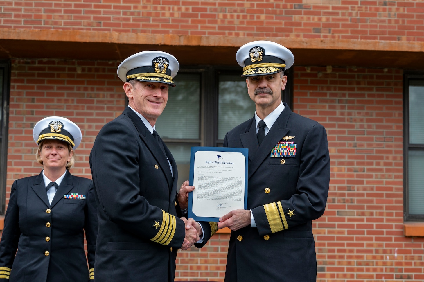 Rear Adm. Michael Steffen presents a Meritorious Unit Commendation to Capt. Daniel Layton, commanding officer of Mobilization and Deployment Support Command, during the launch ceremony for Mobilization and Deployment Support Command.