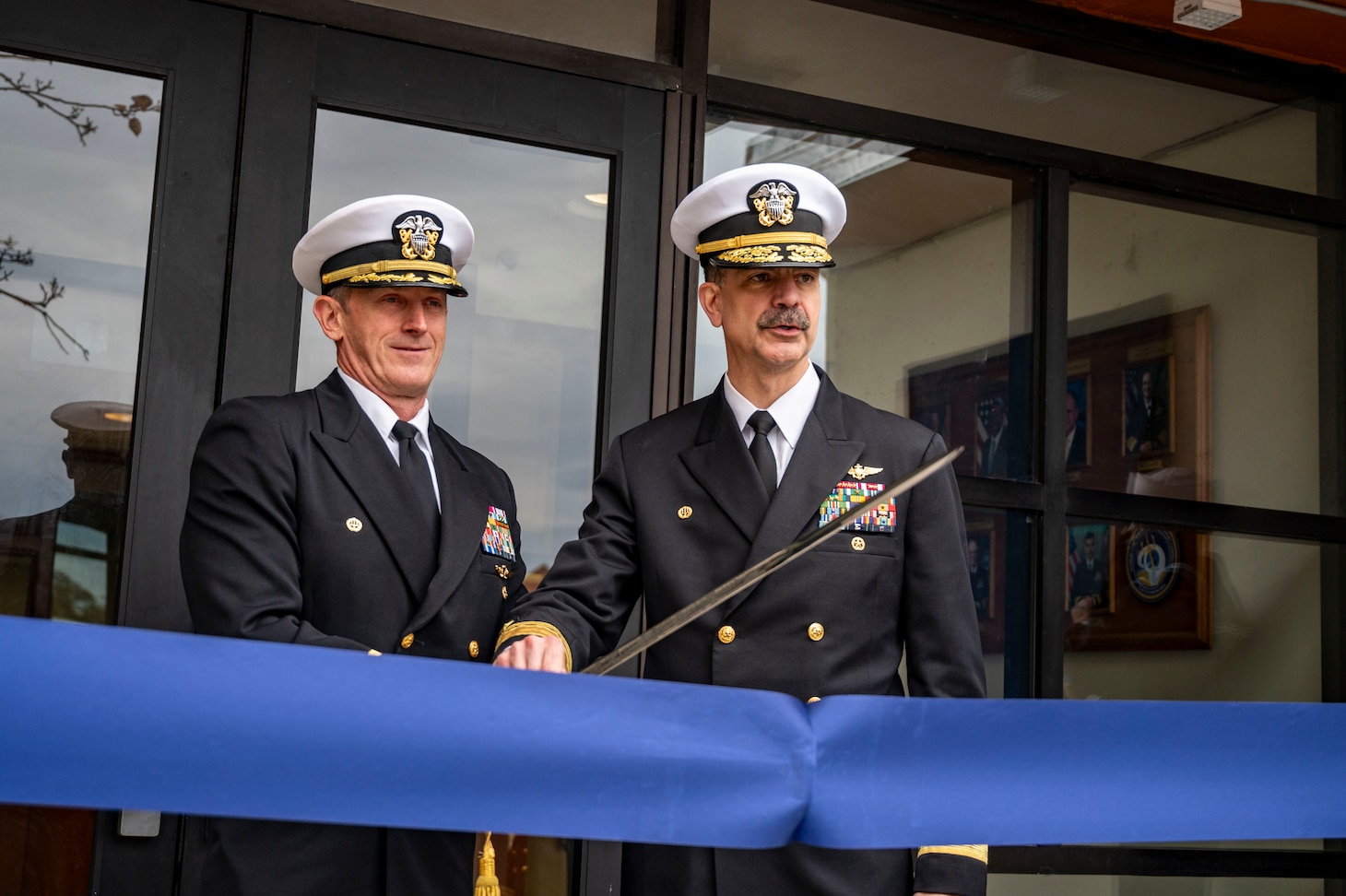 Rear Adm. Michael Steffen and Capt. Daniel Layton, commanding officer of Mobilization and Deployment Support Command, cut a ribbon during the launch ceremony for Mobilization and Deployment Support Command.