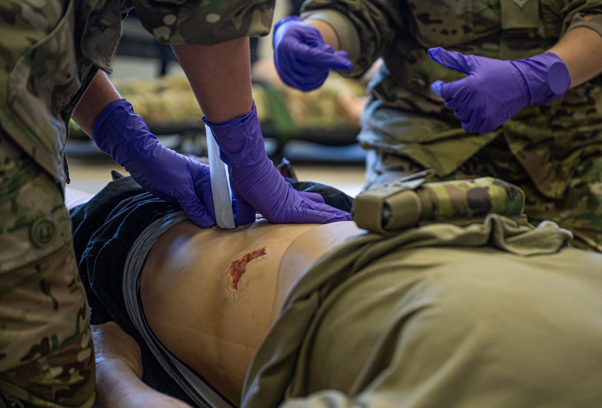 Danish air force 1st Lt. Freya Lyngso packs a wound on a medical mannequin during a demonstration at Ramstein Air Base, Germany, Nov. 29, 2023. Lyngso and other members from Denmark joined personnel from Bulgaria, Serbia and the U.S. for a knowledge exchange where they participated in demonstrations and briefings where they traded information they may find useful at their home stations. (U.S. Air Force photo by Senior Airman Thomas Karol)