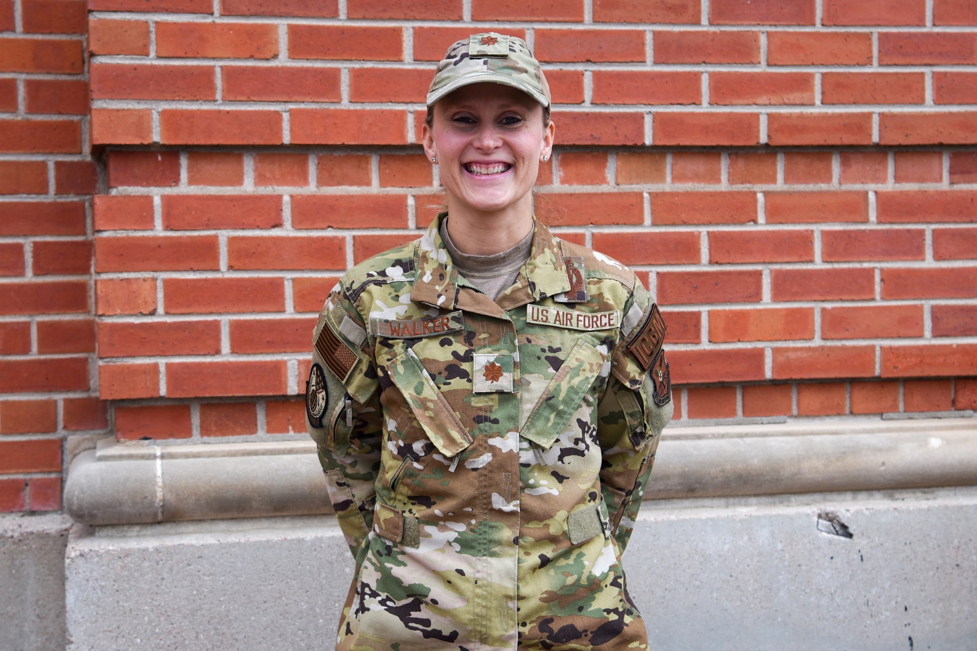 female Airman in front of building