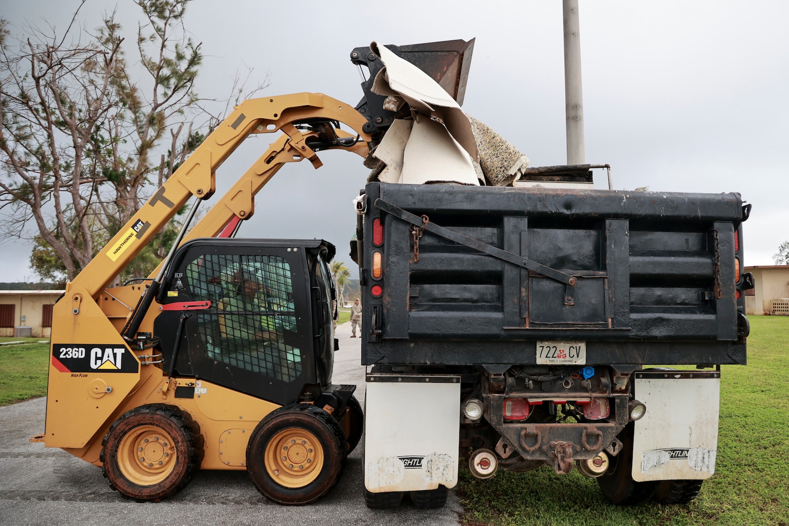 Airman 1st Class A1C Kierr Calvo of the Guam Air National Guard’s 254th Red Horse Squadron clears demolition debris from an unoccupied housing neighborhood on Andersen Air Force Base, Guam, Nov. 27, 2023. Calvo is activated with a group of 30 Guam Guardsmen tasked to restore 50 homes for rotational forces in Guam. (U.S. National Guard photo by Mark Scott)