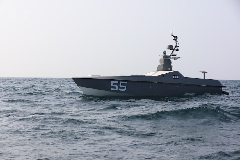 An unmanned surface vessel patrols in open waters.