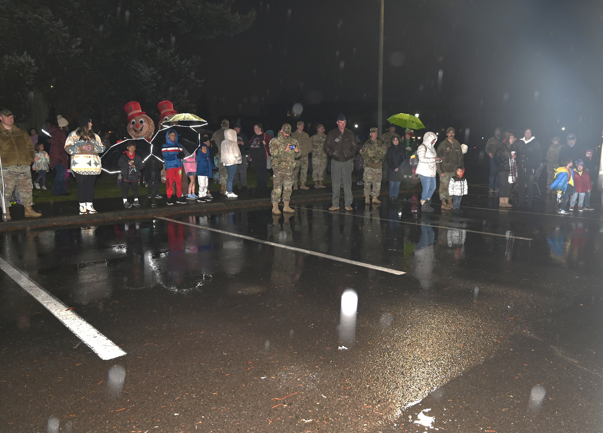 Despite the drizzle common to the Pacific Northwest, Team McChord Airmen and families gather to witness the annual holiday tree lighting ceremony at Joint Base Lewis-McChord, Wash., Nov. 30, 2023. Hot chocolate, cookies, and other desserts were provided by the USO. Children were able to take pictures with Mrs. and Mr. Clause along with two gingerbread men. Providing holiday recreational family activities is one of the ways Team McChord develop ready Airmen and families.