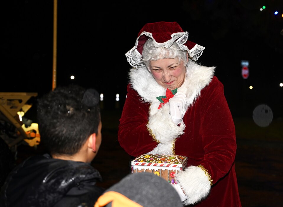Despite the drizzle common to the Pacific Northwest, Team McChord Airmen and families gather to witness the annual holiday tree lighting ceremony at Joint Base Lewis-McChord, Wash., Nov. 30, 2023. Hot chocolate, cookies, and other desserts were provided by the USO. Children were able to take pictures with Mrs. and Mr. Clause along with two gingerbread men. Providing holiday recreational family activities is one of the ways Team McChord develop ready Airmen and families.