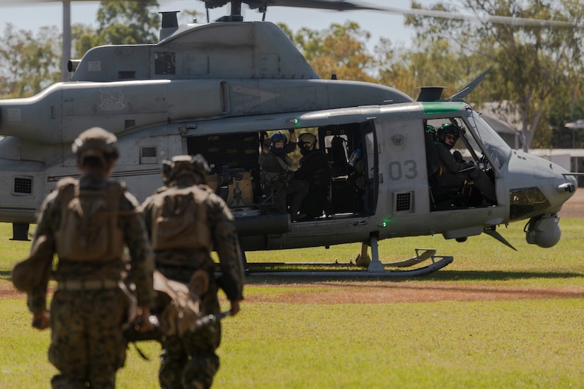 Troops evacuate simulated casualty to a helicopter.