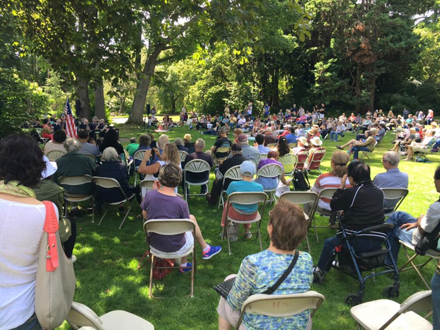 Photo of people listening to a band perform in the Charles S. English Jr. Botanical Garden, Seattle