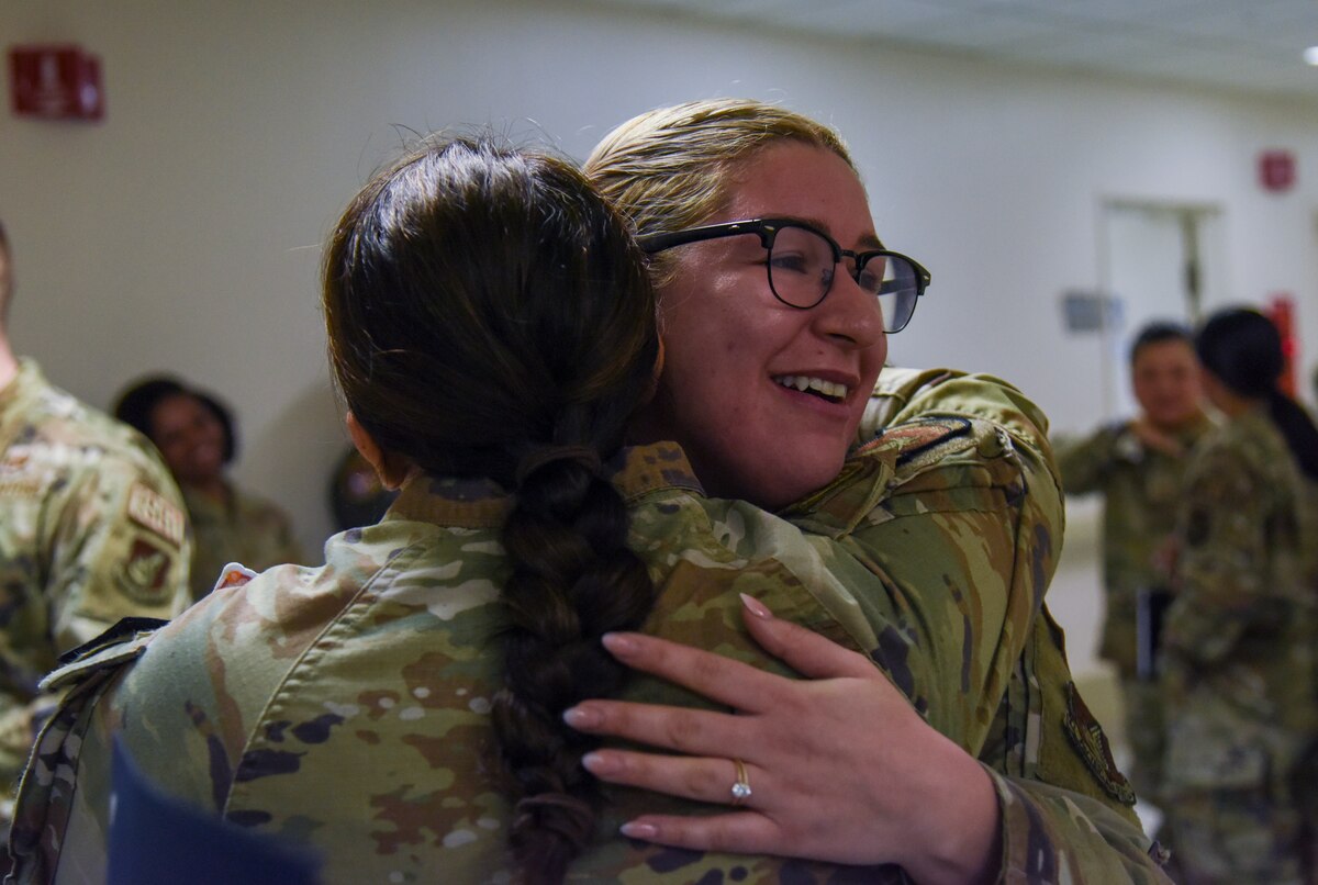 U.S. Air Force Staff Sgt. Ashley Ortiz, 35th Medical Support Squadron pharmacy technician, hugs a wingman after being promoted to technical sergeant under the Stripes for Exceptional Performers program.