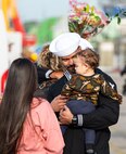 A Sailor assigned to the Arleigh Burke-class guided-missile destroyer USS Paul Ignatius (DDG 117) greets his family on the pier at Naval Station (NAVSTA) Rota as the ship returns from deployment, Nov. 28, 2023. As the "Gateway to the Mediterranean,” NAVSTA Rota provides U.S, NATO and allied forces a strategic hub for operations in Europe, Africa and the Middle East. NAVSTA Rota is a force multiplier, capable of promptly deploying and supporting combat-ready forces through land, air and sea, enabling warfighters and their families, sustaining the fleet and fostering the U.S. and Spanish partnership. (U.S. Navy photo by Mass Communication Specialist 2nd Class Drace Wilson)