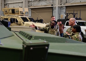 airman pointing at a vehicle