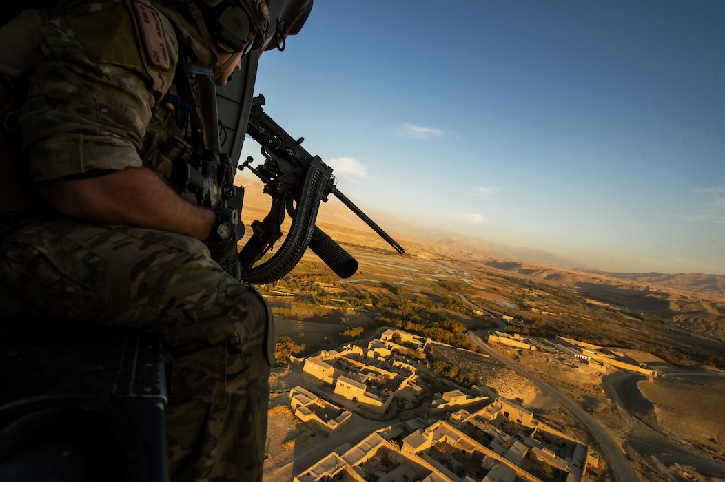 A U.S. Air Force pararescueman scans out the open door of an HH-60 helicopter for ground threats while flying over Afghanistan. Pararescue teams assault, secure, and dominate the rescue objective area utilizing any available Department of Defense or allied, air, land, or sea asset. (U.S. Air Force photo/Staff Sgt. Jonathan Snyder)