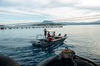 Sailors assigned to Naval Support Activity (NSA) Souda Bay’s port operation team assist in bringing in the first-in-class aircraft carrier USS Gerald R. Ford (CVN 78) as the ship arrives in Souda Bay, Crete, for a scheduled port visit on Dec. 2, 2023. USS Gerald R. Ford Carrier Strike Group is on a scheduled deployment in the U.S. Naval Forces Europe-Africa area of operations, employed by U.S. Sixth Fleet to defend U.S., allied and partner interests. NSA Souda Bay is an operational ashore installation which enables and supports U.S., Allied, Coalition, and Partner nation forces to preserve security and stability in the European, African, and Central Command areas of responsibility. (U.S. Navy photo by Mass Communication Specialist 1st Class Delaney S. Jensen)