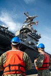 Sailors assigned to Naval Support Activity (NSA) Souda Bay prepare to heave line before bringing in the first-in-class aircraft carrier USS Gerald R. Ford (CVN 78) as the ship arrives in Souda Bay, Crete, for a scheduled port visit on Dec. 2, 2023. USS Gerald R. Ford Carrier Strike Group is on a scheduled deployment in the U.S. Naval Forces Europe-Africa area of operations, employed by U.S. Sixth Fleet to defend U.S., allied and partner interests. NSA Souda Bay is an operational ashore installation which enables and supports U.S., Allied, Coalition, and Partner nation forces to preserve security and stability in the European, African, and Central Command areas of responsibility.