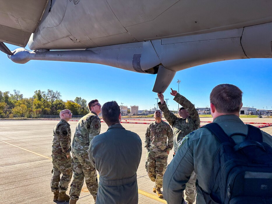 people looking up at a plane