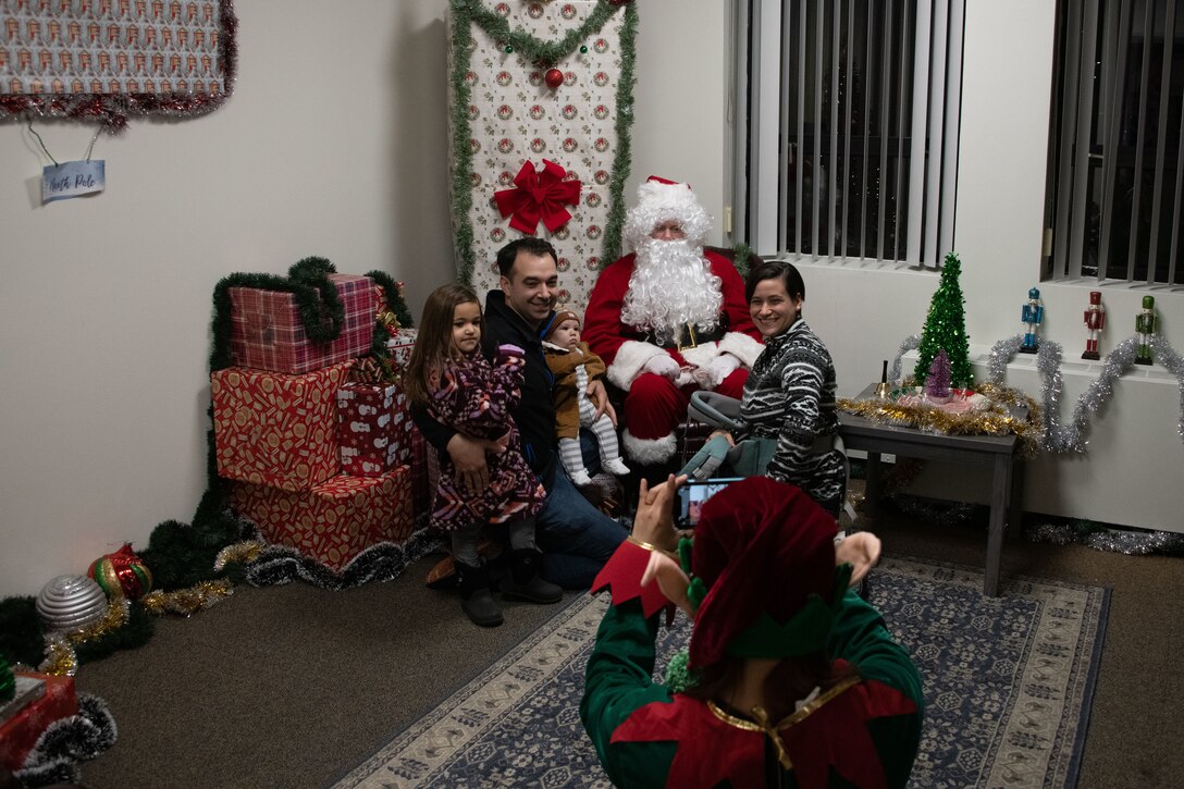 A family takes a photo with Santa Claus
