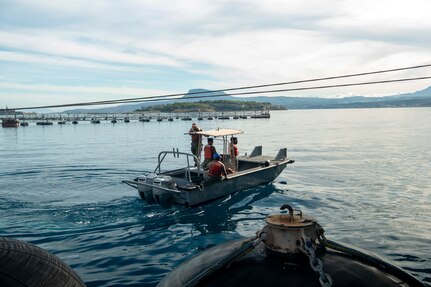 Sailors assigned to Naval Support Activity (NSA) Souda Bay’s port operation team assist in bringing in the first-in-class aircraft carrier USS Gerald R. Ford (CVN 78) as the ship arrives in Souda Bay, Crete, for a scheduled port visit on Dec. 2, 2023. USS Gerald R. Ford Carrier Strike Group is on a scheduled deployment in the U.S. Naval Forces Europe-Africa area of operations, employed by U.S. Sixth Fleet to defend U.S., allied and partner interests. NSA Souda Bay is an operational ashore installation which enables and supports U.S., Allied, Coalition, and Partner nation forces to preserve security and stability in the European, African, and Central Command areas of responsibility. (U.S. Navy photo by Mass Communication Specialist 1st Class Delaney S. Jensen)