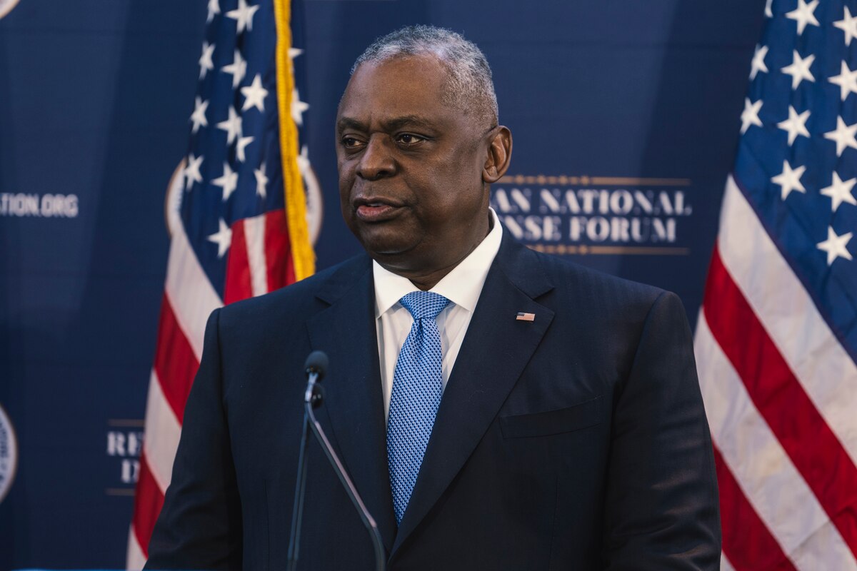 A man speaks  from a podium.