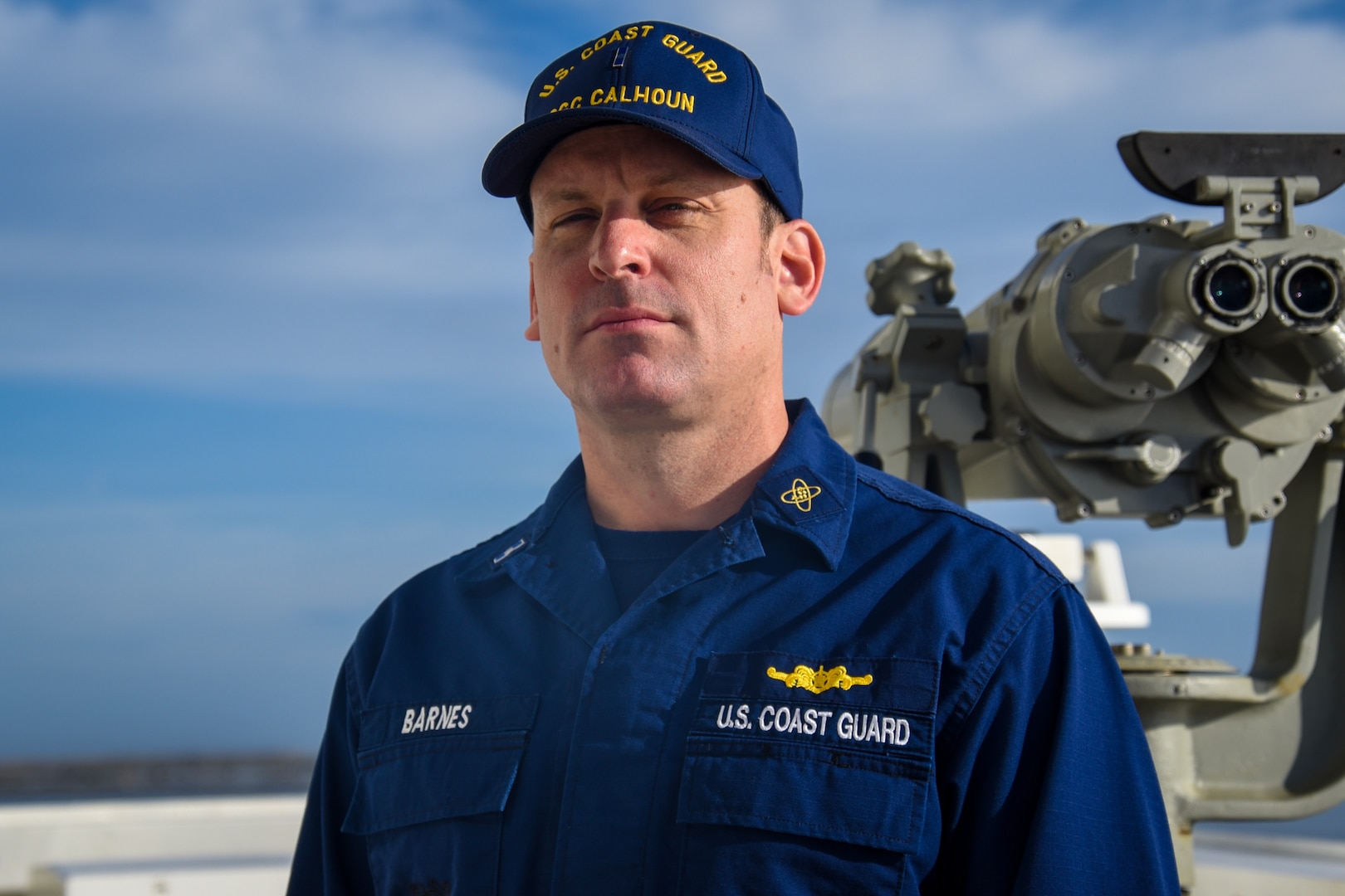 U.S. Coast Guard Chief Warrant Officer Nathan Barnes, the electronics material officer, poses for a portrait near the pilothouse of the Coast Guard Cutter Calhoun (WMSL 759) at Naval Station Mayport, Florida, Dec. 1, 2023. Barnes is originally from Charleston, South Carolina, where the Calhoun, the Coast Guard’s 10th national security cutter, will be homeported.
