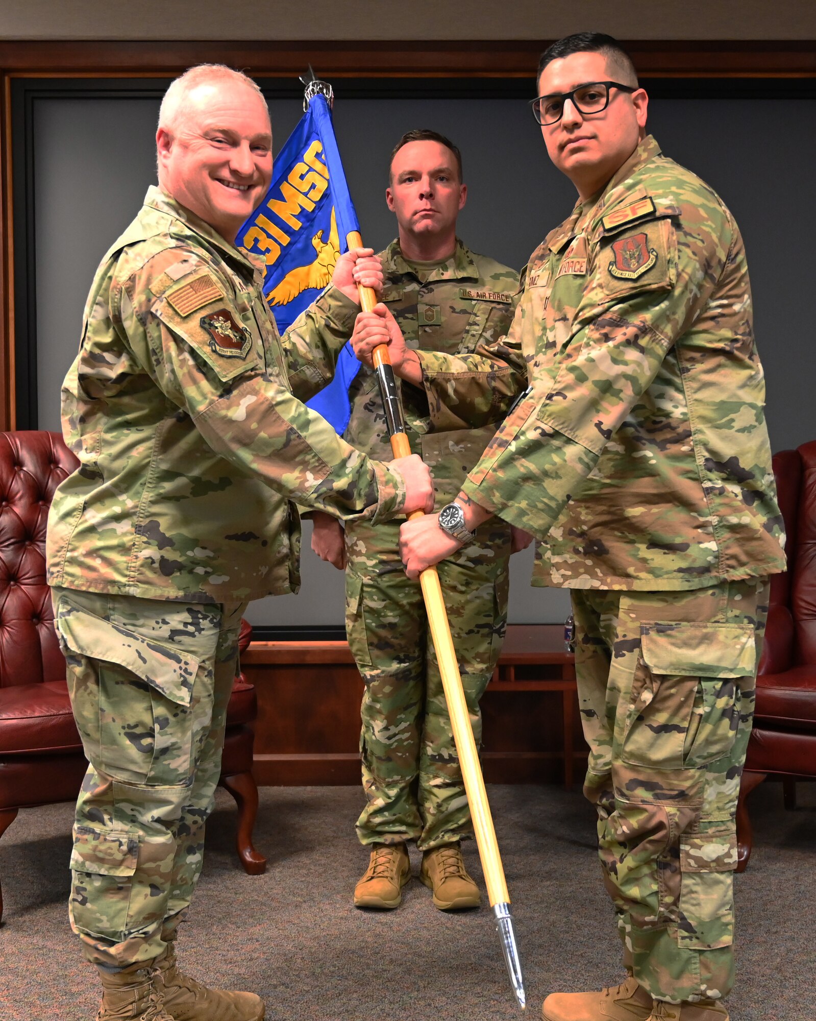 (Left to right) Col. Matt Basler, 931st Mission Support Group commander, hands the guidon to  Capt. Bryan Gomez, 931st Security Forces Squadron incoming commander during an assumption of command ceremony Dec. 2 at McConnell Air Force Base, Kansas.