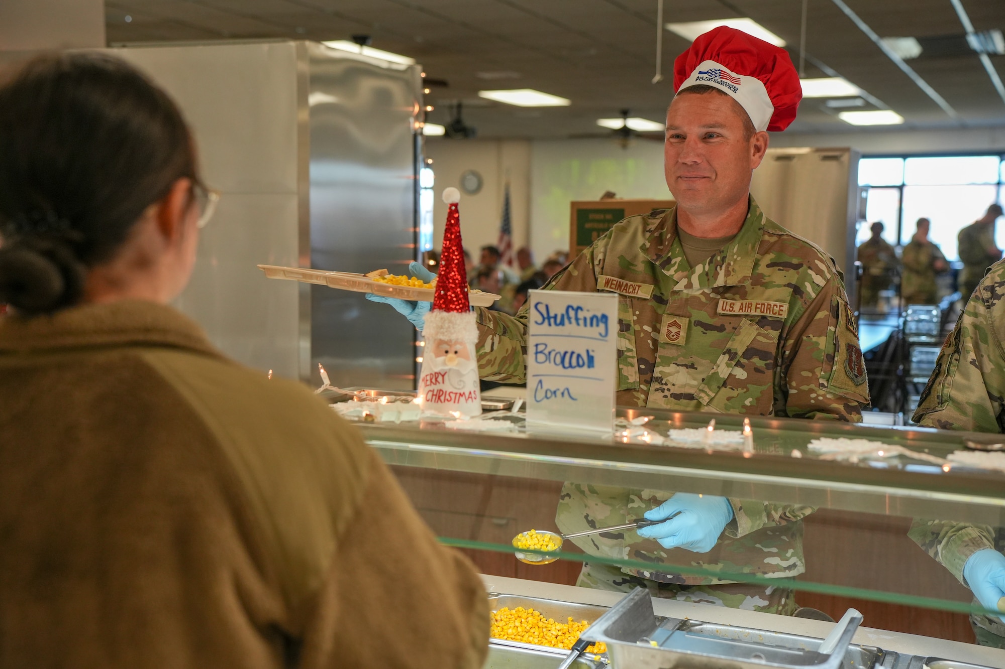 U.S. Air National Guard Chief Master Sgt. Chad Weinacht, maintenance operations superintendent, 114th Maintenance Group, 114th Fighter Wing, South Dakota National Guard, serves a holiday meal to Airmen during December's unit training assembly at Joe Foss Field, South Dakota, December 2, 2023.