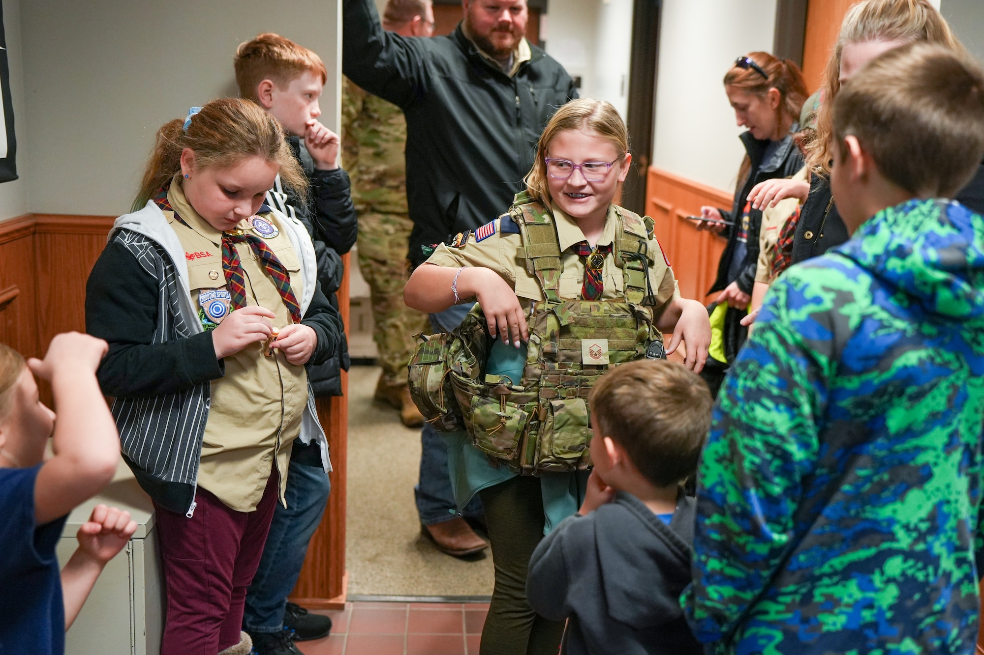 Anna Lewis, 10, a member of Boy Scouts of America Sioux Council Pack 208, tries on the gear of a Security Forces member during a trip to the South Dakota Air National Guard during December's unit training assembly at Joe Foss Field, December 2, 2023.