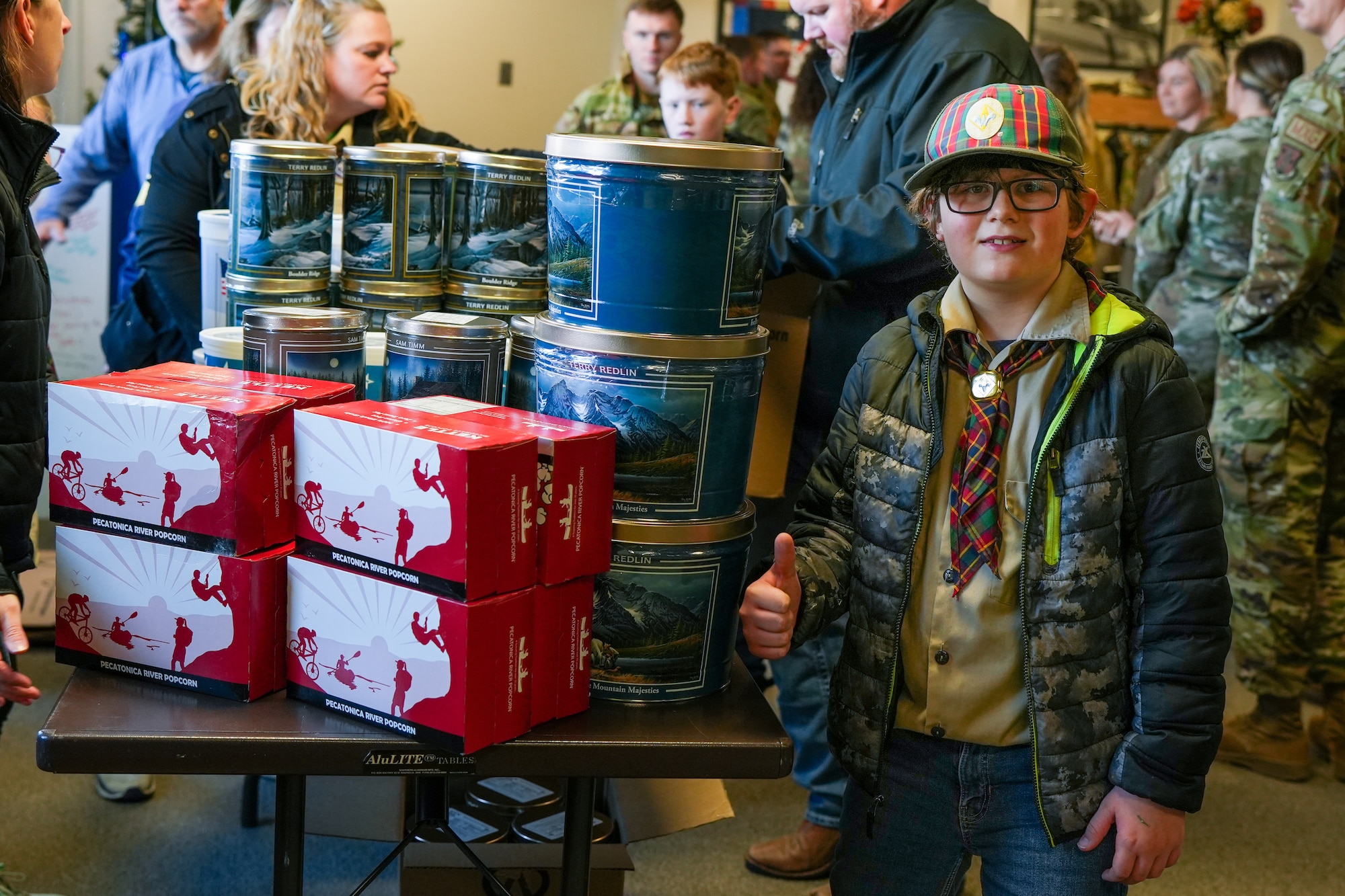 Levis Rasmus, 9, a member of Boy Scouts of America Sioux Council Pack 208, poses next to a table filled with popcorn the pack brought to members of the South Dakota Air National Guard during December's unit training assembly, marking the launch of a partnership between the two organizations, December 2, 2023.