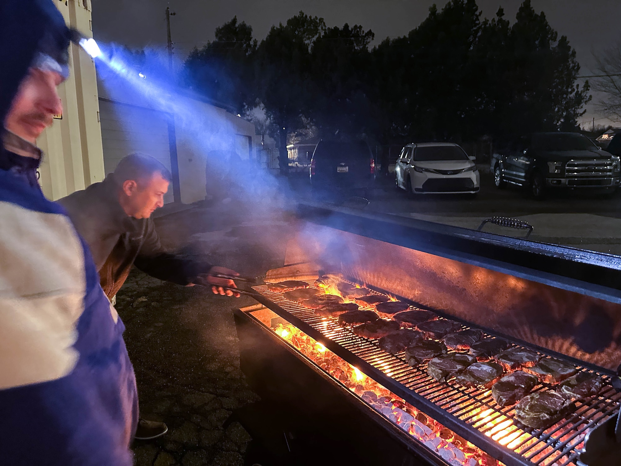 People grilling steaks