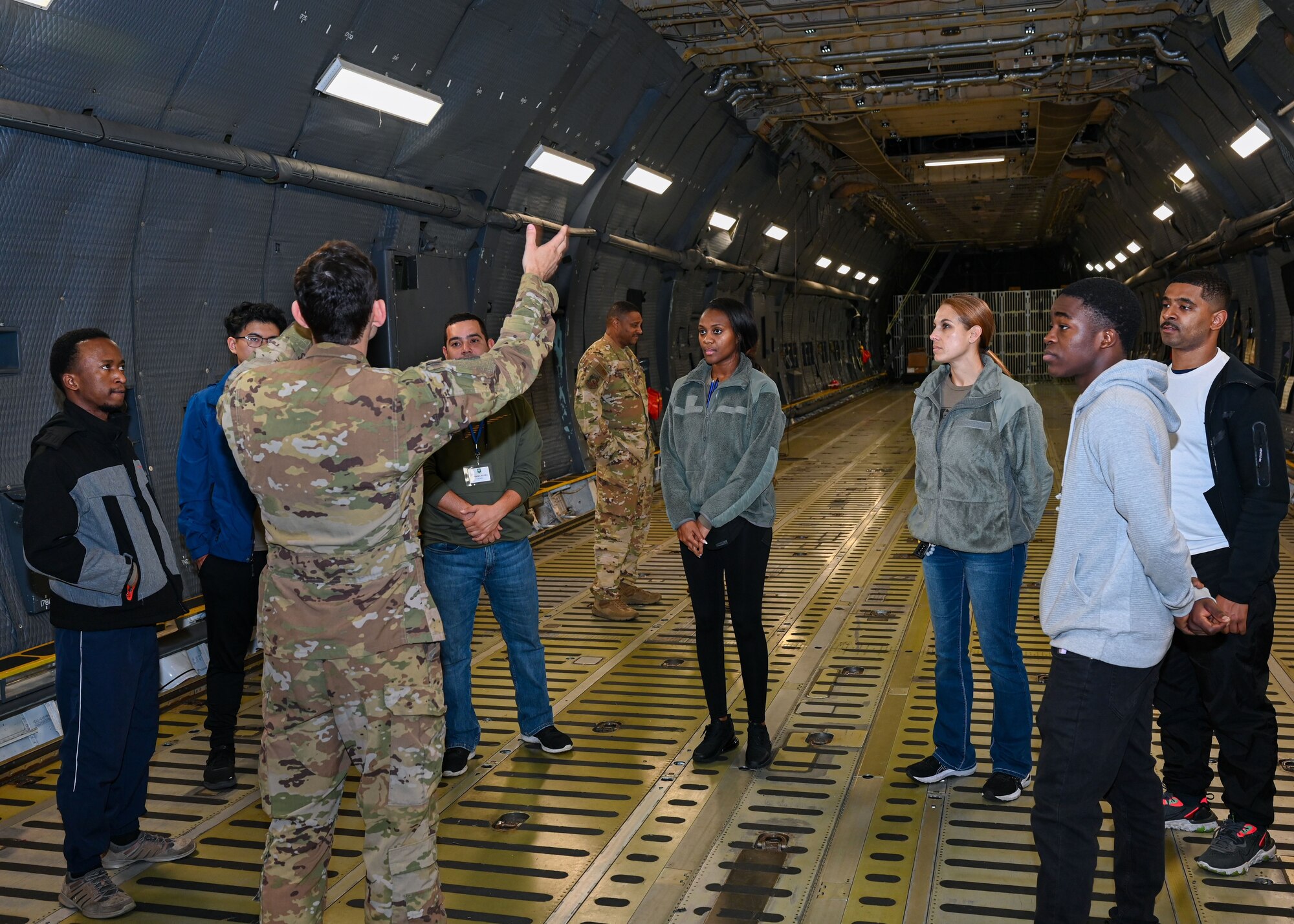 Senior Airman William Slaughter, 709th Airlift Squadron flight engineer, answers questions from members of the 512th Development and Training Flight during a tour of one of Dover’s C-5M Super Galaxy aircraft. Slaughter and other 709th AS gave the DTF a tour of the aircraft during the December Unit Training Assembly. (U.S. Air Force photo by Senior Airman Shayna Hodge)