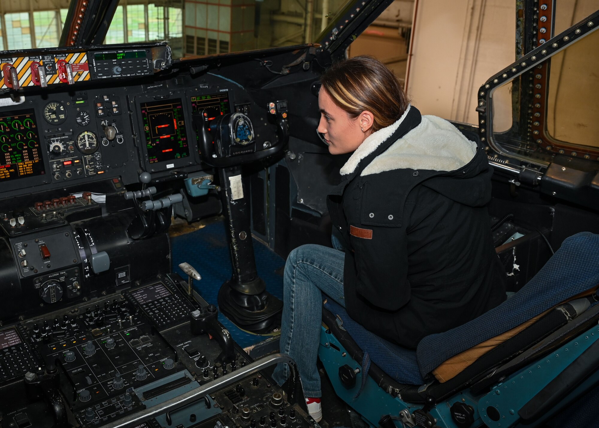 Trainee Nicole Franco, a member of the 512th Development and Training Flight, sits in the flight deck of a C-5M Super Galaxy aircraft on Dover Air Force Base, Delaware, Dec. 2, 2023. Each member of the DTF explored the flight deck during a tour of the aircraft that the 709th AS provided. (U.S. Air Force photo by Senior Airman Shayna Hodge).